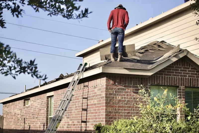 Professional roofer working on a residential roof in The Farm at Woods Creek